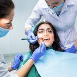 Dental doctors examining patient.