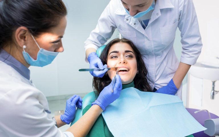 Dental doctors examining patient.