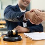 lawyer or attorneys shaking hand with client after consultation discussing a contract agreement customer at courtroom, judge service concept